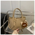 Detail of lychee pattern leather tote bag in khaki with creative plush monster charm - Khaki With Pendant