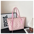 Detail of pink tote bag with rabbit monogram print and premium faux leather texture - Pink