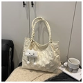 Detail of cream tote bag with quilted bear patterns and woven handle and plush charm - Off-white with Pendant
