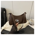 Close-up of matte dark brown faux leather underarm bag with silver square buckle clasp - Coffee
