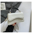 Minimalist white square handbag with wavy quilted flap and gold hardware in hand - White