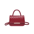 Deep red quilted crossbody bag with stylish bear pattern embossing and gold metal detail - Red
