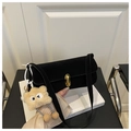 Black faux suede shoulder bag with gold twist lock and plush star charm detail - Black With Pendant