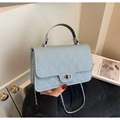 Detail of light blue quilted leather handbag with silver rotary lock and chain strap - Blue