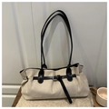 Detail of off-white suede tote bag with black leather strap on a knitted sweater - Khaki