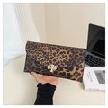 Close-up of leopard print envelope clutch bag with gold ripple metal buckle and leather texture - Brown Leopard Print