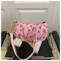 Detail of pink shoulder bag with cherry pattern, gold chain, and zipper closure - Pink