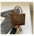 Detail of dark brown pebble leather tote bag with silver FASHION metallic lettering - Coffee