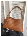 Chic brown woven leather handbag with a matching charm for stylish women's fashion - Brown