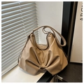 Detail of beige bow-shaped shoulder bag featuring soft pleated leather and zipper closure - Khaki
