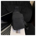 Detailed macro view of the black crossbody bag with durable texture and front zipper - Black