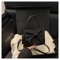 Makroaufnahme der schwarzen Pailletten-Abendtasche mit Schleife in Geschenkbox - Schwarz