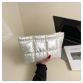 Quilted off-white puffy makeup bag with elegant stitch detail in a lifestyle setting - White