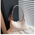 Detailed shot of beige lychee leather handbag handle wrapped with letter silk scarf - White