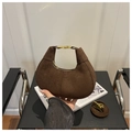 Macro shot of dark brown suede hobo bag with luxury golden buckle and zipper detail - Coffee