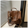 Détail d'un sac à dos vintage marron avec fermoir métallique et breloque lapin tricoté - Marron avec Pendentif