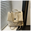 Detailed shot of beige faux leather handbag with elegant metal twist lock on a windowsill - Rice White (No Pendant)