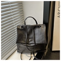 Detail of black oil wax leather backpack with silver twist-lock and matte texture - Black without Pendant