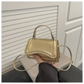Mini metallic gold crossbody bag with top handle and stylish embossed texture lines - Gold