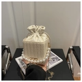 Cream white woven bucket bag with large pearl handle and golden chain strap - Beige