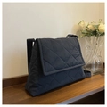 Bolso bandolera acolchado azul marino con diseño de diamantes y solapa sobre madera - Azul