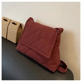 Quilted crossbody bag in deep red finish with padded texture and adjustable strap - Red