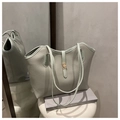 Detail of mint green tote bag featuring lychee textured leather and gold metal clasp - Green