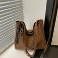 Brown canvas tote bag with long shoulder straps and decorative charm in natural window light - With Pendant / Brown