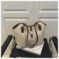 Detail of cream leather tote bag featuring a gold twist lock and brown contrast piping - Off White