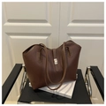 Detail of dark brown lychee pattern leather tote bag with elegant metal twist lock closure - Coffee