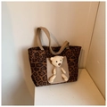 Detail of canvas tote bag featuring leopard print pattern and 3D plush bear ornament - Coffee