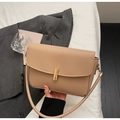 Detailed close-up of beige leather shoulder bag with golden rectangle twist lock and smooth texture - Khaki