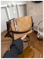 Detail of the diamond quilted stitching and gold rotary metal lock on the vintage handbag - Brown
