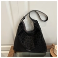 Detailed view of the leopard print suede tote bag placed on a wooden side table - Black Without Pendant