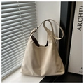 Detailed view of the creamy white faux leather tote bag with subtle logo text print - White Without Pendant