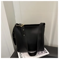 Minimalist black leather bucket bag with wide strap and large gold metal buckle - Black