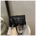 Detail of black faux leather shoulder bag with silver square buckle and side zipper accents - Black