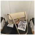 Detail of beige crocodile embossed handbag with premium golden twist lock and shoulder strap - Khaki