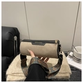 Close-up of suede cylinder bag with gold zipper and patterned bohemian wide strap - Khaki