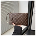 Detail of vintage brown clutch with geometric pattern, zipper closure and wrist strap - Clover Coffee