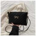 Chic black quilted crossbody bag with a gold metal bow and a slim shoulder strap - Black