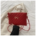 Chic red quilted crossbody bag with gold metal bow charm and elegant diamond pattern - Red