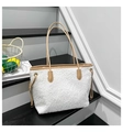 Detail of white plush tote bag showing soft sherpa texture and brown leather trim accents - White