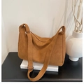 Detail showing warm brown suede hobo bag with adjustable strap and metal hardware - Brown