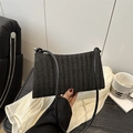 Chic black woven tote bag with V-shaped texture and slim strap in a stylish setting - With Pendant / Black