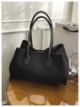 Detail view of large black matte tote bag showing the smooth texture and slim handles - Black