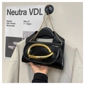 Minimalist black patent leather crossbody bag with a large gold abstract metal buckle - Black