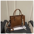 Deep brown faux leather tote bag with gold lettering and woven charm pendant - Brown