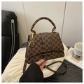 Detailed shot of brown messenger bag with letter print and gold hardware on white cloth - Style M Coffee