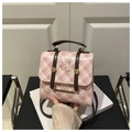 Detailansicht des rosa karierten Rucksacks mit Welpendruck und goldenem Logo-Schild - Rosa